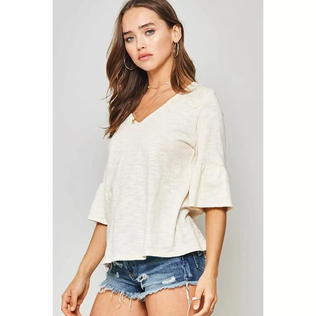 A Knit Top With Deep V Neckline And Yoke Design